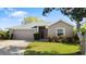 Charming single-story home featuring a well-manicured lawn, a two-car garage and lovely landscaping at 6123 Jasmine Vine Dr, Port Orange, FL 32128