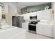 Bright kitchen featuring white cabinets, stainless steel appliances, and tiled floors at 6123 Jasmine Vine Dr, Port Orange, FL 32128