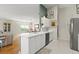 Well-lit kitchen with a view into the breakfast nook and the living room at 6123 Jasmine Vine Dr, Port Orange, FL 32128