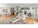 Open-concept living room with hardwood floors, neutral decor, and a view of the kitchen and dining area at 6123 Jasmine Vine Dr, Port Orange, FL 32128