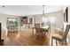 Inviting living room with wood floors, a dining area, and a large window at 6123 Jasmine Vine Dr, Port Orange, FL 32128