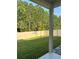 Spacious backyard with lush green grass, privacy fence, and a patio at 137 Eagle Harbor Way, Daytona Beach, FL 32124