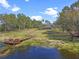 Breathtaking aerial view of the property highlighting the house, pool, lake, and surrounding greenery at 22527 Lake Seneca Rd, Eustis, FL 32736