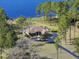 Aerial view of a house with a screened pool, dock, and lake access at 22527 Lake Seneca Rd, Eustis, FL 32736