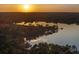 Sunset view overlooking the lake and horizon, with silhouettes of trees reflecting in the calm water at 22527 Lake Seneca Rd, Eustis, FL 32736