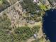 Aerial view of an estate showcasing its sprawling lot, private pool, lake frontage, and long driveway at 22527 Lake Seneca Rd, Eustis, FL 32736