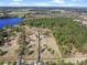 Beautiful aerial view of the vast property showing tree coverage, grassy areas, and a private road at 22527 Lake Seneca Rd, Eustis, FL 32736