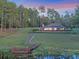 Expansive backyard featuring a screened pool, beautiful lawn and a private dock at 22527 Lake Seneca Rd, Eustis, FL 32736