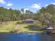 Beautiful lakefront property with a long wooden dock, lake access, and meticulously manicured grounds at 22527 Lake Seneca Rd, Eustis, FL 32736