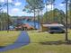 A house with a long drive and detached garage located on a lake at 22527 Lake Seneca Rd, Eustis, FL 32736