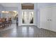 Spacious foyer with double front door, gray-tiled flooring, light blue walls, and lots of natural light at 22527 Lake Seneca Rd, Eustis, FL 32736