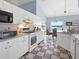 Well-lit kitchen featuring white appliances, checkerboard floors, and a breakfast nook at 22527 Lake Seneca Rd, Eustis, FL 32736