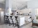 Open kitchen area with bar seating and white cabinetry, seamlessly connecting to the dining space at 22527 Lake Seneca Rd, Eustis, FL 32736