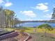 Serene lake view from a meticulously landscaped backyard with access to dockside amenities at 22527 Lake Seneca Rd, Eustis, FL 32736