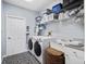 This laundry room features modern machines, ample storage, and a convenient utility sink with tiled floors at 22527 Lake Seneca Rd, Eustis, FL 32736