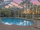 Screened pool overlooking a wooded setting; perfect for relaxation and enjoying nature at 22527 Lake Seneca Rd, Eustis, FL 32736