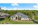 An elevated perspective of a beautiful single-story home with a well-kept yard and mature trees at 3428 Rexford Cir, Ormond Beach, FL 32174