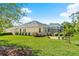 Beautiful backyard featuring a lush lawn, mature trees, and a screened-in lanai that's perfect for outdoor entertaining at 3428 Rexford Cir, Ormond Beach, FL 32174