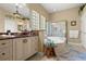 Bathroom featuring dual vanity sinks, walk-in shower, a soaking tub, and decorative tile throughout at 3428 Rexford Cir, Ormond Beach, FL 32174