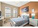 Bedroom with great natural light features white furniture, colorful bedding, and neutral walls at 3428 Rexford Cir, Ormond Beach, FL 32174