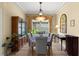 Formal dining room featuring a decorative light fixture, stylish furniture, and a large window at 3428 Rexford Cir, Ormond Beach, FL 32174