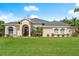 Beautiful single-story home featuring a well-manicured lawn and a welcoming red-door entryway at 3428 Rexford Cir, Ormond Beach, FL 32174