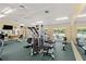 Community gym with multiple machines, weights, mirrors and windows for a bright workout experience at 3428 Rexford Cir, Ormond Beach, FL 32174