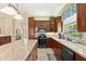 This kitchen features an island, stainless steel appliances, and ample counter space for food preparation at 3428 Rexford Cir, Ormond Beach, FL 32174