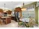 Charming eat-in kitchen featuring wood cabinets, granite countertops and a breakfast nook at 3428 Rexford Cir, Ormond Beach, FL 32174