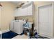 Laundry room with overhead cabinets, modern washer and dryer, and plenty of space for cleaning supplies at 3428 Rexford Cir, Ormond Beach, FL 32174
