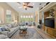 Spacious living room featuring large windows, comfortable seating and a decorative ceiling fan at 3428 Rexford Cir, Ormond Beach, FL 32174