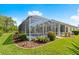 Inviting screened-in pool area with lush landscaping, perfect for outdoor relaxation and entertaining at 3428 Rexford Cir, Ormond Beach, FL 32174
