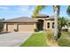 Charming single-story home with a well-manicured lawn, complemented by mature landscaping and a three-car garage at 1316 Harwick Ln, Ormond Beach, FL 32174