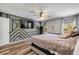 A bedroom showcases a modern accent wall, wood floors, and windows that provide natural light at 225 Perfect Dr, Daytona Beach, FL 32124