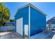 Showcases the detached, light blue workshop with a metal roof, offering potential for various hobbies at 318 Eastwood Dr, Daytona Beach, FL 32118