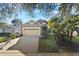 View of attractive home featuring attached garage, manicured lawn, and mature landscaping at 3220 Galty Cir, Ormond Beach, FL 32174