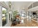 Sun-drenched sunroom with tile floors, comfortable seating, and large windows offering serene outdoor views at 3220 Galty Cir, Ormond Beach, FL 32174