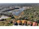 Scenic aerial shot featuring homes with red tile roofs and a lush, wooded backdrop with a large swamp at 410 Viola Dr, Davenport, FL 33837