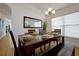 Bright dining room featuring a dark wood table and seating for six at 410 Viola Dr, Davenport, FL 33837