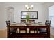 Bright dining room featuring a dark wood table and seating for six at 410 Viola Dr, Davenport, FL 33837