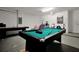 Spacious game room features a billiard table and a variety of entertainment options for Gathering and friends at 410 Viola Dr, Davenport, FL 33837