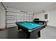 Inside a game room, a billiard table sits beside a garage door and an air hockey table, promising hours of entertainment at 410 Viola Dr, Davenport, FL 33837