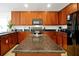 Kitchen featuring dark wood cabinetry, granite countertops, and a center island with storage at 410 Viola Dr, Davenport, FL 33837