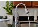 Kitchen featuring a modern chrome faucet, dark countertops, and a sleek black sink at 410 Viola Dr, Davenport, FL 33837