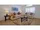 Bright living room featuring neutral furniture, decorative pillows, and a round coffee table on a colorful area rug at 410 Viola Dr, Davenport, FL 33837