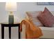 Comfortable living room featuring decorative pillows and throw blanket, accented by a stylish lamp on an end table at 410 Viola Dr, Davenport, FL 33837