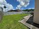 Spacious backyard with green grass, a white fence, and room for outdoor seating and recreation at 105 Cattail Ct, Kissimmee, FL 34743