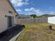 View of the backyard with a patio, sliding glass doors, and fencing at 105 Cattail Ct, Kissimmee, FL 34743