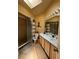 Bright bathroom features a skylight, walk-in shower, and double sink vanity at 105 Cattail Ct, Kissimmee, FL 34743