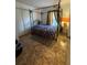 Bedroom features ornate bed frame and tile floors at 105 Cattail Ct, Kissimmee, FL 34743